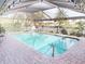 Enclosed pool area with canal view, lounge chairs, and brick pavers at 116 Colonial Sw St, Port Charlotte, FL 33952
