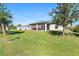 Large backyard with a spacious screened porch and lush lawn at 12333 Willmington Blvd, Port Charlotte, FL 33981
