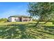 Landscaped backyard showcasing a large, well-maintained lawn at 12333 Willmington Blvd, Port Charlotte, FL 33981
