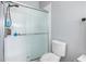 Clean bathroom with a shower, toilet, and textured glass door at 12333 Willmington Blvd, Port Charlotte, FL 33981