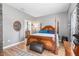 Main bedroom with a large wooden bed frame and ensuite bathroom at 12333 Willmington Blvd, Port Charlotte, FL 33981