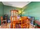 Dining room features a wood table and hutch against a green wall at 12333 Willmington Blvd, Port Charlotte, FL 33981