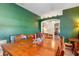 Bright dining room featuring a wood table and green accent wall at 12333 Willmington Blvd, Port Charlotte, FL 33981