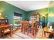 Formal dining room with wood table and chairs, green walls, and hardwood floors at 12333 Willmington Blvd, Port Charlotte, FL 33981