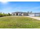 Single-story home with attached garage and spacious lawn at 12333 Willmington Blvd, Port Charlotte, FL 33981