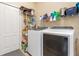 Laundry room with washer, dryer, and shelving for storage at 12333 Willmington Blvd, Port Charlotte, FL 33981