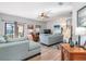 Spacious living room with light teal sofas and wood-look floors at 12333 Willmington Blvd, Port Charlotte, FL 33981
