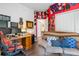 Home office with two workspaces, comfortable seating, and red walls at 12333 Willmington Blvd, Port Charlotte, FL 33981