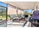 Relaxing screened porch with wicker furniture, creating an outdoor oasis at 12333 Willmington Blvd, Port Charlotte, FL 33981
