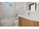 Bathroom with a bathtub, toilet and modern vanity at 14431 Artesia Ave, Port Charlotte, FL 33981