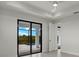 Bright bedroom featuring sliding glass doors opening to a private patio and pool at 14431 Artesia Ave, Port Charlotte, FL 33981