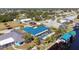 Aerial view of a waterfront home featuring an enclosed pool area, boat dock, and canal access at 161 Carlisle Nw Ave, Port Charlotte, FL 33952