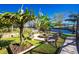 Picturesque backyard with fire pit, seating, and waterfront view creates an inviting outdoor living space at 161 Carlisle Nw Ave, Port Charlotte, FL 33952