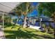 Waterfront backyard, view of dock and boat lift, tropical landscaping, bright blue skies at 161 Carlisle Nw Ave, Port Charlotte, FL 33952