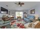 Relaxing living room with comfortable seating and large TV at 17396 Cox Ave, Port Charlotte, FL 33948
