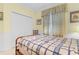 Bedroom with wooden bed frame and window at 17458 Fuego Ln, Punta Gorda, FL 33955