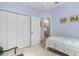 Bedroom with white bed frame and view of dining room at 17458 Fuego Ln, Punta Gorda, FL 33955