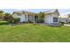 Single-story house with metal roof, landscaped lawn, and screened porch at 17458 Fuego Ln, Punta Gorda, FL 33955