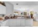 Kitchen with white cabinets, view into living room at 17458 Fuego Ln, Punta Gorda, FL 33955