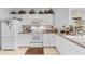 Bright kitchen features white cabinets, and a microwave at 17458 Fuego Ln, Punta Gorda, FL 33955