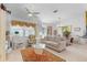 Living room with comfy seating, large windows, and a ceiling fan at 17458 Fuego Ln, Punta Gorda, FL 33955