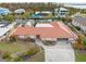 An aerial view of the rear elevation of a waterfront home with a pool, dock, boat lift, and canal access at 1923 Pennsylvania Ave, Englewood, FL 34224