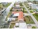 Aerial shot of a waterfront home featuring a screened pool, boat lift, and access to a private dock and canal at 1923 Pennsylvania Ave, Englewood, FL 34224