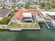 An aerial shot of a waterfront home featuring a screened-in pool, dock, boat lift and direct canal access at 1923 Pennsylvania Ave, Englewood, FL 34224