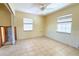 Cozy bedroom with tile flooring, two windows providing natural light, and exposed wall studs at 1923 Pennsylvania Ave, Englewood, FL 34224
