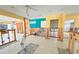 Open concept kitchen space with tile flooring, a ceiling fan, and natural light streaming through windows at 1923 Pennsylvania Ave, Englewood, FL 34224