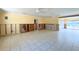 Spacious living room features tile flooring, ceiling fans, and sliding glass doors to the pool at 1923 Pennsylvania Ave, Englewood, FL 34224