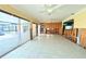 Bright living room with tile floors, multiple sliding glass doors, and abundant natural light at 1923 Pennsylvania Ave, Englewood, FL 34224
