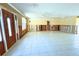 Open concept living room with tiled floors, natural light, and ample space at 1923 Pennsylvania Ave, Englewood, FL 34224