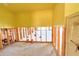Room with unfinished walls, and a doorway with a view into another room at 1923 Pennsylvania Ave, Englewood, FL 34224
