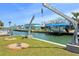 Beautiful waterfront home with boat lifts along a peaceful canal on a sunny day at 1923 Pennsylvania Ave, Englewood, FL 34224