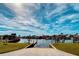 Picturesque view of a boat ramp leading to the water, with lush green grass and a serene sky backdrop at 207 Blackburn Blvd, North Port, FL 34287
