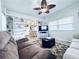Comfortable living room with ceiling fan, and neutral decor, seamlessly flowing into the dining area at 207 Blackburn Blvd, North Port, FL 34287