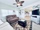 Inviting living room featuring a ceiling fan and comfortable furnishings, open to the kitchen at 207 Blackburn Blvd, North Port, FL 34287
