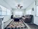 Cozy living room with large windows, ceiling fan, and comfortable furnishings at 207 Blackburn Blvd, North Port, FL 34287
