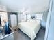 Bright main bedroom with a queen bed, neutral walls, and adjoining bath at 207 Blackburn Blvd, North Port, FL 34287