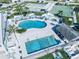 Aerial view of a community pool area with a large swimming pool, lounge chairs, and recreational facilities at 207 Blackburn Blvd, North Port, FL 34287