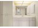 Bathroom featuring white vanity and cabinets at 3800 Bal Harbor Blvd # 312, Punta Gorda, FL 33950