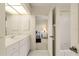 Bathroom with white vanity, shower, and bedroom view at 3800 Bal Harbor Blvd # 312, Punta Gorda, FL 33950