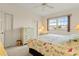 Bedroom featuring floral bedding and dresser at 3800 Bal Harbor Blvd # 312, Punta Gorda, FL 33950