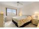 Bright bedroom with floral bedding and ceiling fan at 3800 Bal Harbor Blvd # 312, Punta Gorda, FL 33950