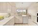 Kitchen with white cabinets, a dishwasher, and a view to the outside at 3800 Bal Harbor Blvd # 312, Punta Gorda, FL 33950