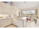 Bright kitchen features white cabinets, modern appliances, and a breakfast nook with water views at 3800 Bal Harbor Blvd # 312, Punta Gorda, FL 33950