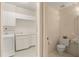 Bright laundry room with washer, dryer, sink, and cabinets at 3800 Bal Harbor Blvd # 312, Punta Gorda, FL 33950