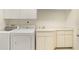 Well-equipped laundry room with washer, dryer, and ample storage at 3800 Bal Harbor Blvd # 312, Punta Gorda, FL 33950