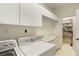 Laundry room with washer, dryer, sink, and extra storage space at 3800 Bal Harbor Blvd # 312, Punta Gorda, FL 33950